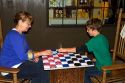 Grandmother and grandson play a game of checkers at a Cracker Barrel in Brandon, Florida, USA.