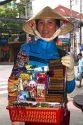 Female street vendor selling souvenirs in Ho Chi Minh City, Vietnam.