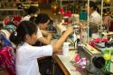 Workers using sewing machines at a clothing factory in Hanoi, Vietnam.