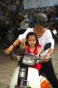 Mother and child riding a motor scooter together in Nha Trang, Vietnam.