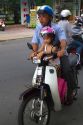 Father and child riding a motor scooter together in Nha Trang, Vietnam.