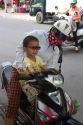 Mother and child riding a motor scooter together in Nha Trang, Vietnam.