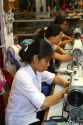 Workers using sewing machines at a clothing factory in Hanoi, Vietnam.