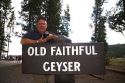 David R. Frazier standing at the sign for Old Faithful Geyser in Yellowstone National Park, Wyoming, USA.