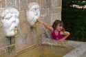 Five year old girl playing in a water fountain at St. Augustine, Florida, USA