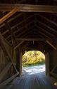 The Mill Covered Bridge crossing the Lamoille River in Belvidere, Vermont, USA.