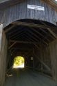 The Mill Covered Bridge crossing the Lamoille River in Belvidere, Vermont, USA.