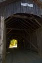 The Mill Covered Bridge crossing the Lamoille River in Belvidere, Vermont, USA.