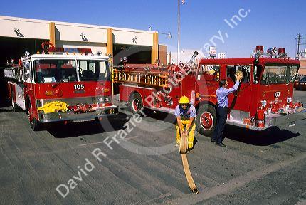 Firemen doing maintenance on fire trucks at a fire station in Caldwell, Idaho.