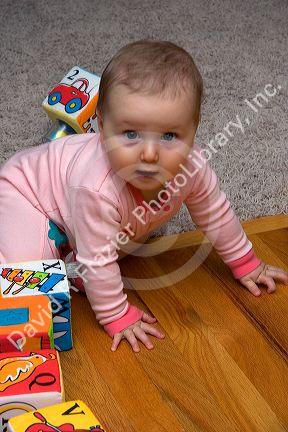 Infant child playing with blocks. MR