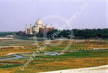 The Taj Mahal and farmland in Agra, India.