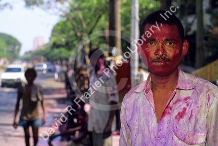 An Indian man wearing Holi Festival colors in India.