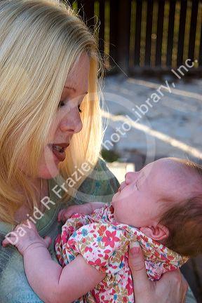 Mother holding her newborn baby girl. MR