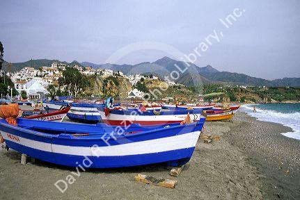 Beach scene with fishing boats in Nerja, Spain.