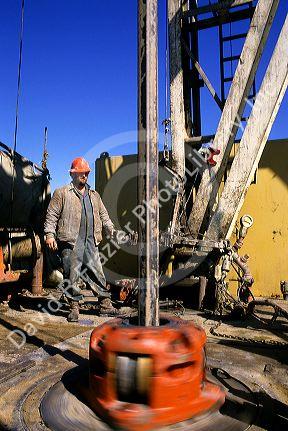 Oil drilling rig and worker in Texas.