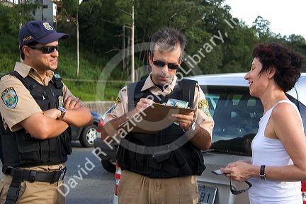Brazilian federal police speak with a woman involved in a traffic accident near Sao Paulo, Brazil.
