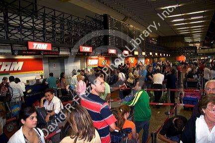Tam ticket counter at a crowded airport in Sao Paulo, Brazil.