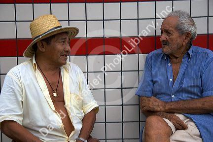 Elderly Brazilian men talk in Manaus, Brazil.