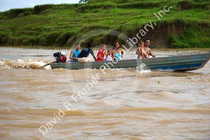 Brazilians ride in a small river boat on the Amazon River near Manaus, Brazil.