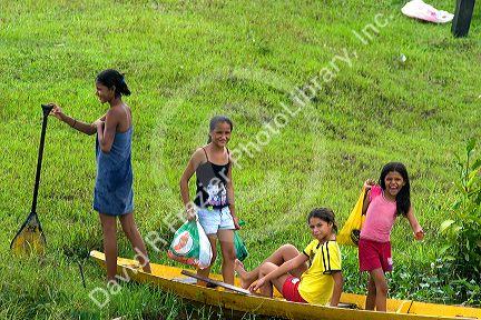 Brazilian girls in a canoe in the Amazon jungle near Manaus, Brazil.