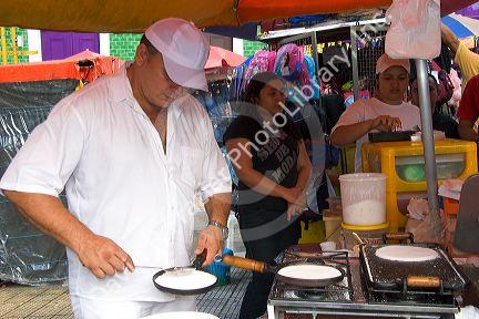 A man cooking tapioca into a kind of pancake in Manaus, Brazil.
