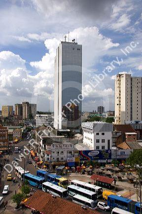 Buses and traffic in Manaus, Brazil.  Tower is a government office building.