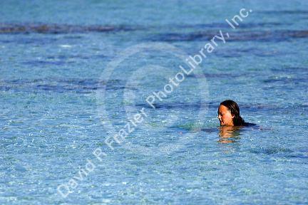 A woman swims in the lagoon off the island of Moorea. MR