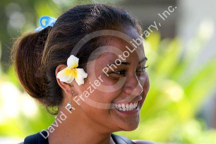 Tahitian woman wearing a plumeria flower in her hair on the island of Moorea.