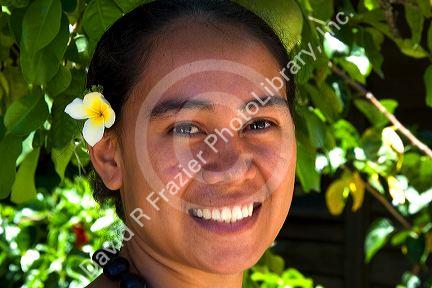 Tahitian woman wearing a plumeria flower in her hair on the island of Moorea.