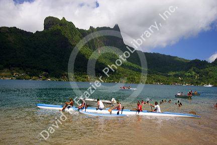 Tahitians take part in an outrigger canoe pirogue race off the island of Moorea.
