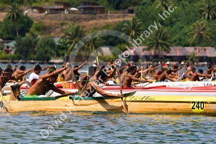 Tahitians take part in an outrigger canoe pirogue race off the island of Moorea.