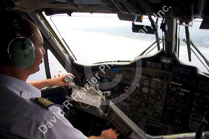 Pilot of Twin Otter aircraft at the controls in the cockpit.