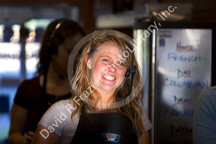 Girl wearing a headset at work in a coffee shop, Boise, Idaho.