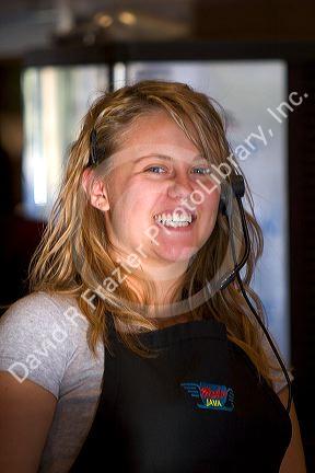 Girl wearing a headset at work in a coffee shop, Boise, Idaho.