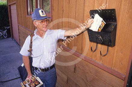 A postal worker delivering mail.