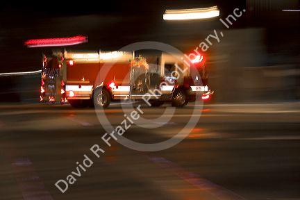 Fire truck in motion at night with lights flashing in Boise, Idaho.