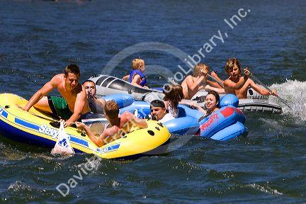 People on inflatable rafts floating the Boise River in Boise, Idaho.