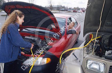 Students jump start a car which has a dead battery.  