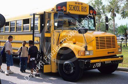School children waiting to get on the school bus.