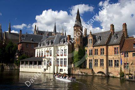 Tourists ride in a canal boat at the city of Bruges in the province of West Flanders, Belgium.