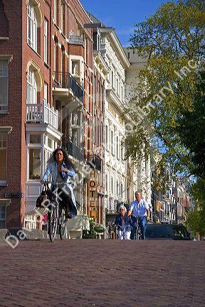 People riding bicycles on the street in Amsterdam, Netherlands.