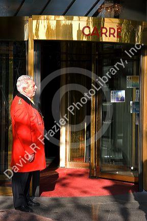 Doorman standing at the entrance to the Royal Carre Theatre in Amsterdam, Netherlands.