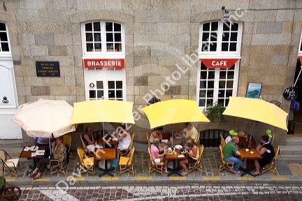 People dine at a sidewalk cafe in Saint-Malo in Brittany, northwestern France.