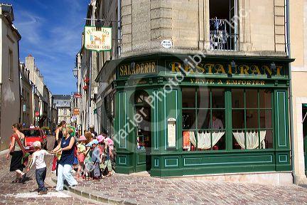 A group of adult supervised French children crossing the street at Bayeux in the region of Basse-Normandie, Normandy, France.