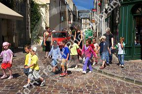 A group of adult supervised French children crossing the street at Bayeux in the region of Basse-Normandie, Normandy, France.