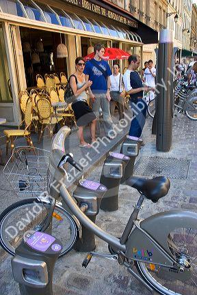 People rent bicycles at a Velib muni-meter as part of the bike transit system in Paris, France.