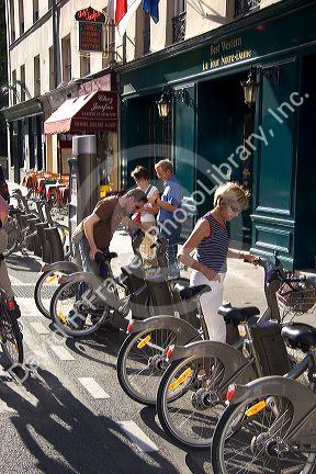 People use rental bicycles that are a part of the Velib bike transit system in Paris, France.