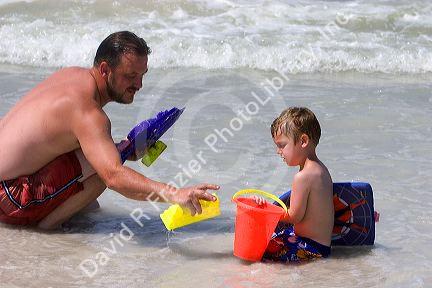 Father and son play on the beach at St. Petersburg, Florida. MR