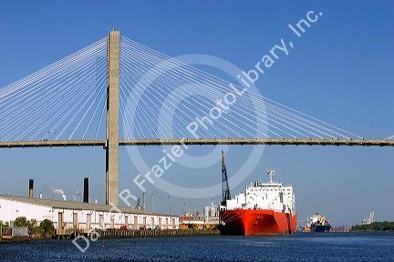 Container ships pass under the Talmadge Memorial Bridge on the Savannah River at the Port of Savannah in Savannah, Georgia.