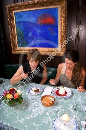 Women eating desert at the Kronenhalle restaurant in Zurich, Switzerland. MRswitzerland, swiss, europe, european, travel, tourism, swiss alps, alps, alpine, zurich, desert, kronenhalle, restaurant, painting, chagall, chagall painting, art